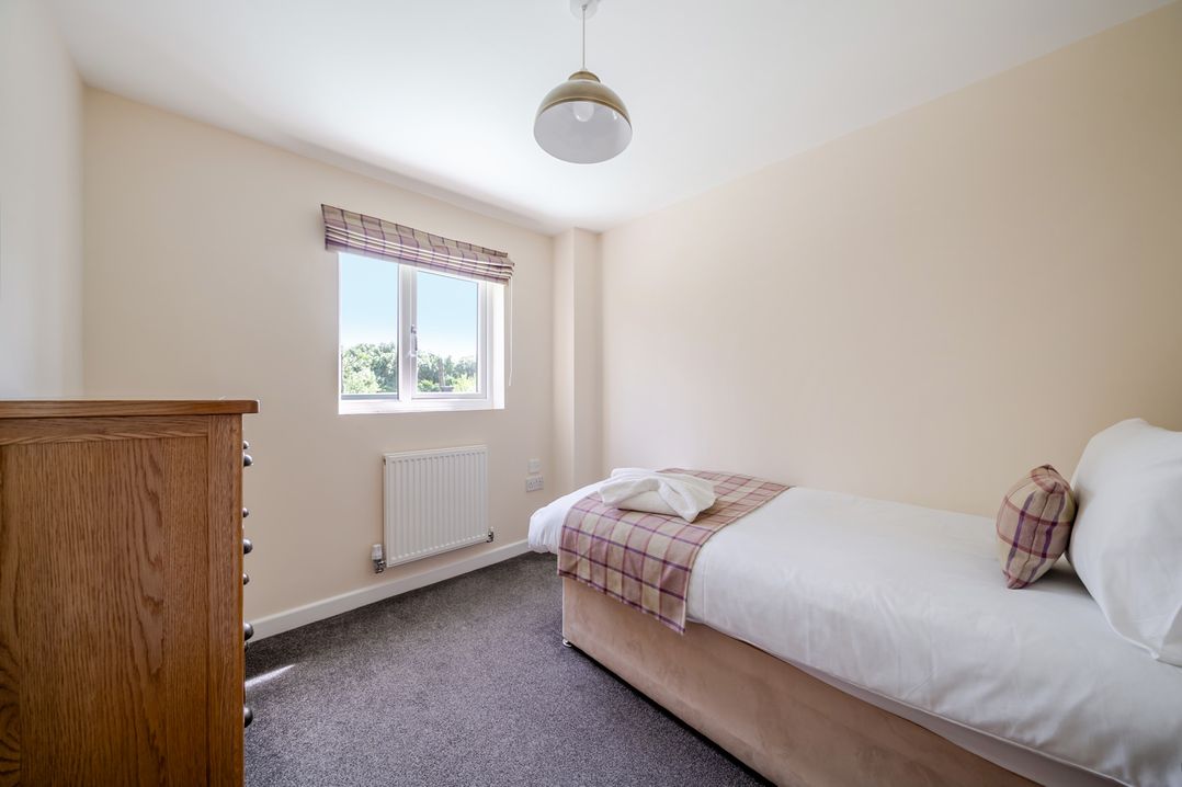 A bedroom with a bed and window at Paddington Lodge Near Brigg