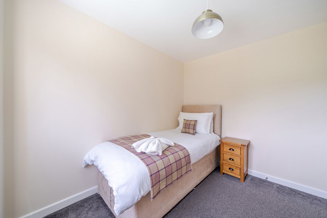 A bedroom with a bed and nightstand at Paddington Lodge near Brigg