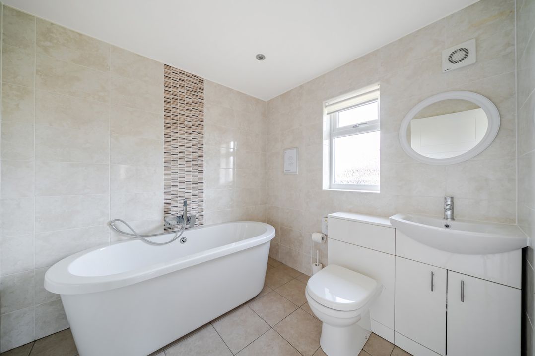 A bathroom with a bath tub and sink at Paddington Lodge Near Brigg