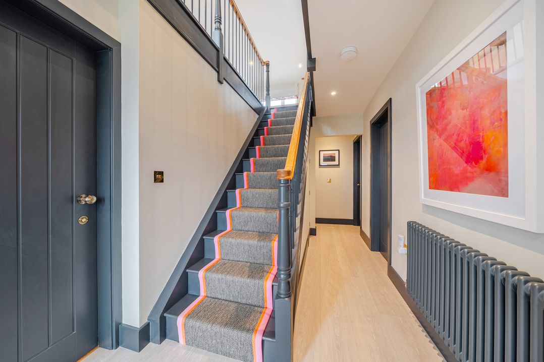 A staircase in a hallway at Bell House Llanfechell
