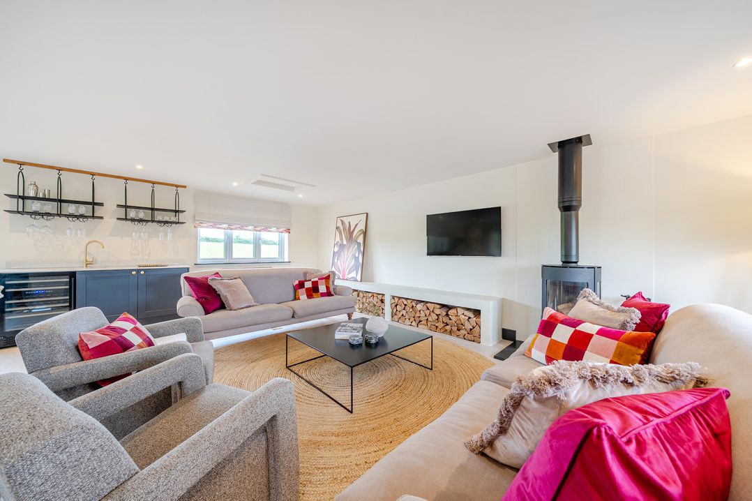 A living room with a sofa and armchairs at Bell House in Llanfechell