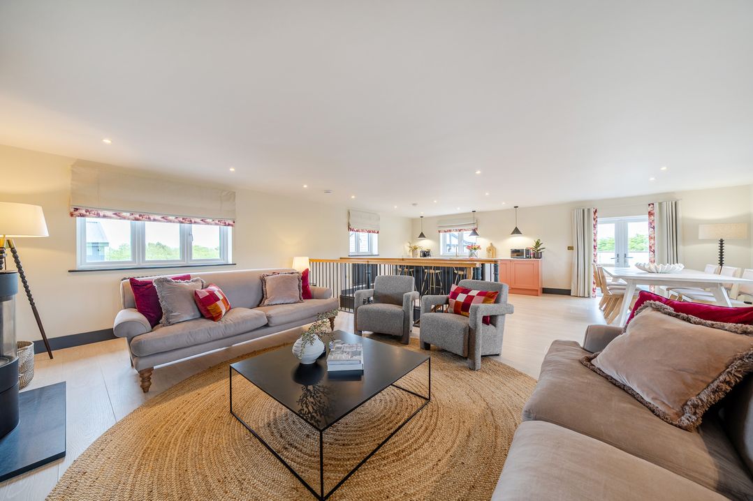 A living room with a sofa and armchairs at Bell House in Llanfechell