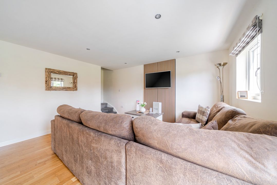 A living room with a sofa and television at James Ville Marina Lodge 8 in Brigg