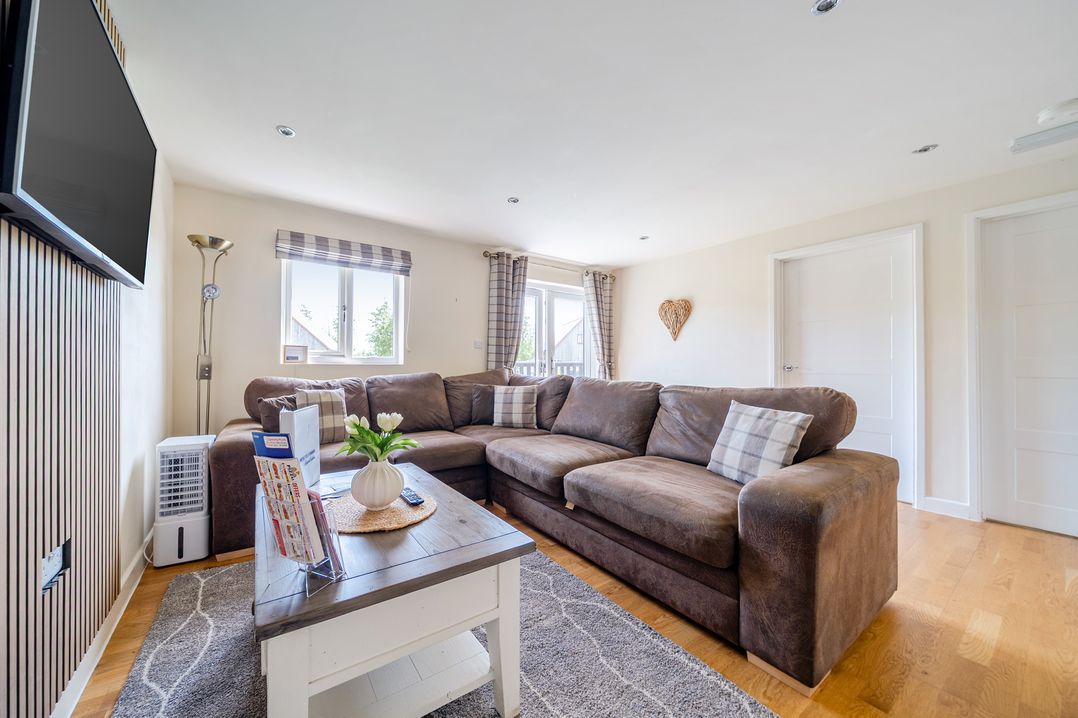 A living room with a sofa and television at James Ville Marina Lodge 8 in Brigg