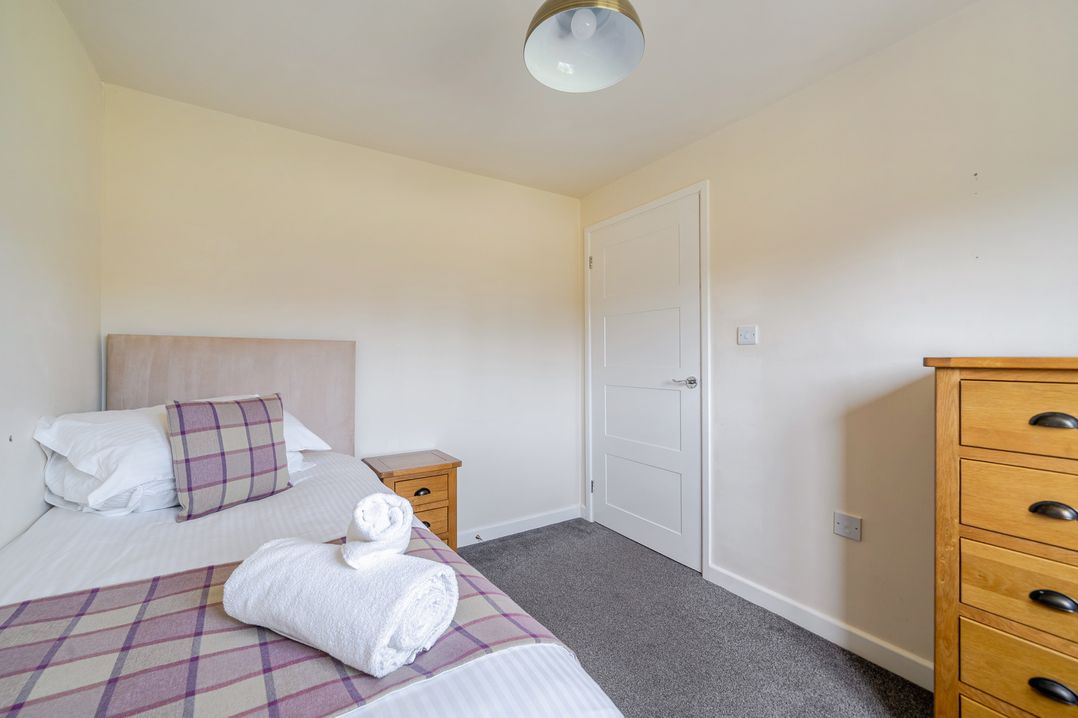 A bedroom with a bed and nightstand at James Ville Marina Lodge 8 in Brigg