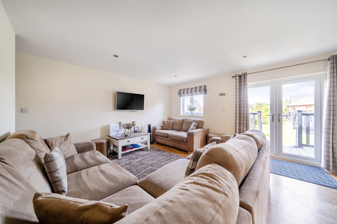 A living room with a television and a sofa at James Ville Marina Lodge 13 in Brigg