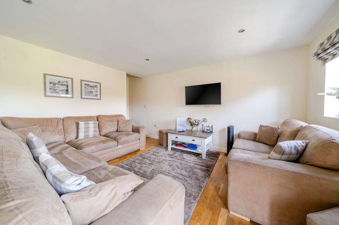 A living room with a television and two sofas at James Ville Marina Lodge 13 in Brigg