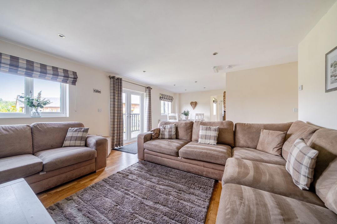 A living room with a sofa and a table at James Ville Marina Lodge 13 in Brigg