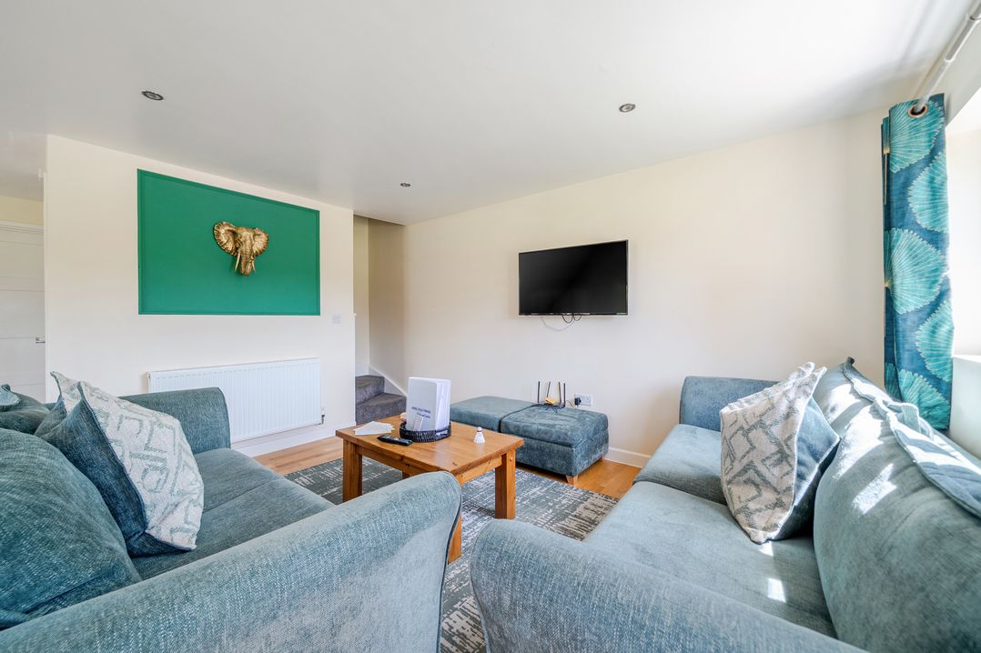 A living room with a sofa and television at James Ville Marina Lodge 22 in Brigg