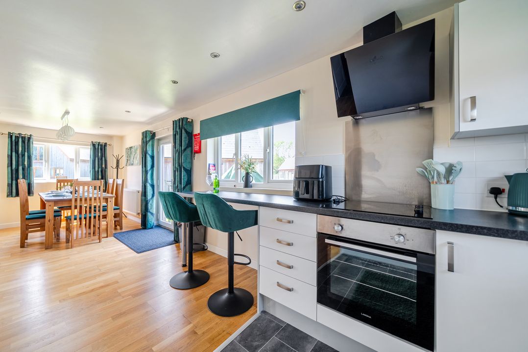 A kitchen with dining table and bar stools at James Ville Marina Lodge 22 Brigg