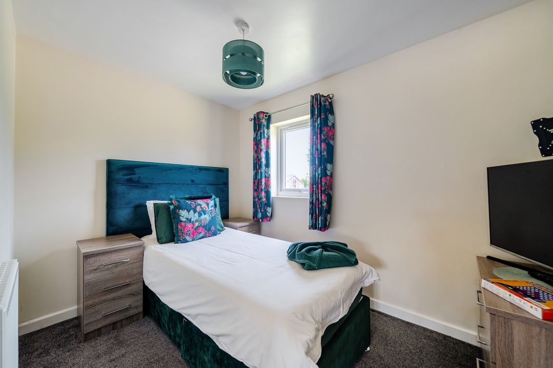A bedroom with a bed and bedside tables at James Ville Marina Lodge 22 in Brigg
