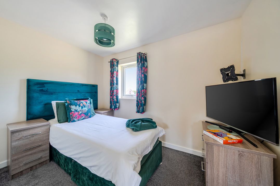 A bedroom with a bed and television at James Ville Marina Lodge 22 in Brigg