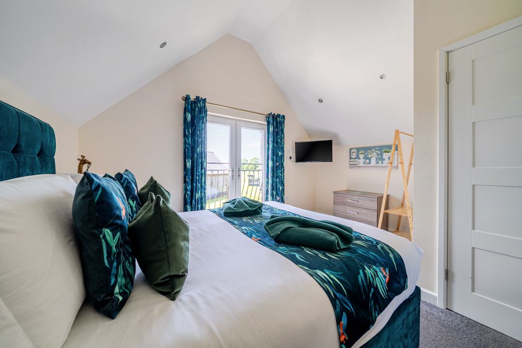 A bedroom with a bed and television at James Ville Marina Lodge 22 in Brigg