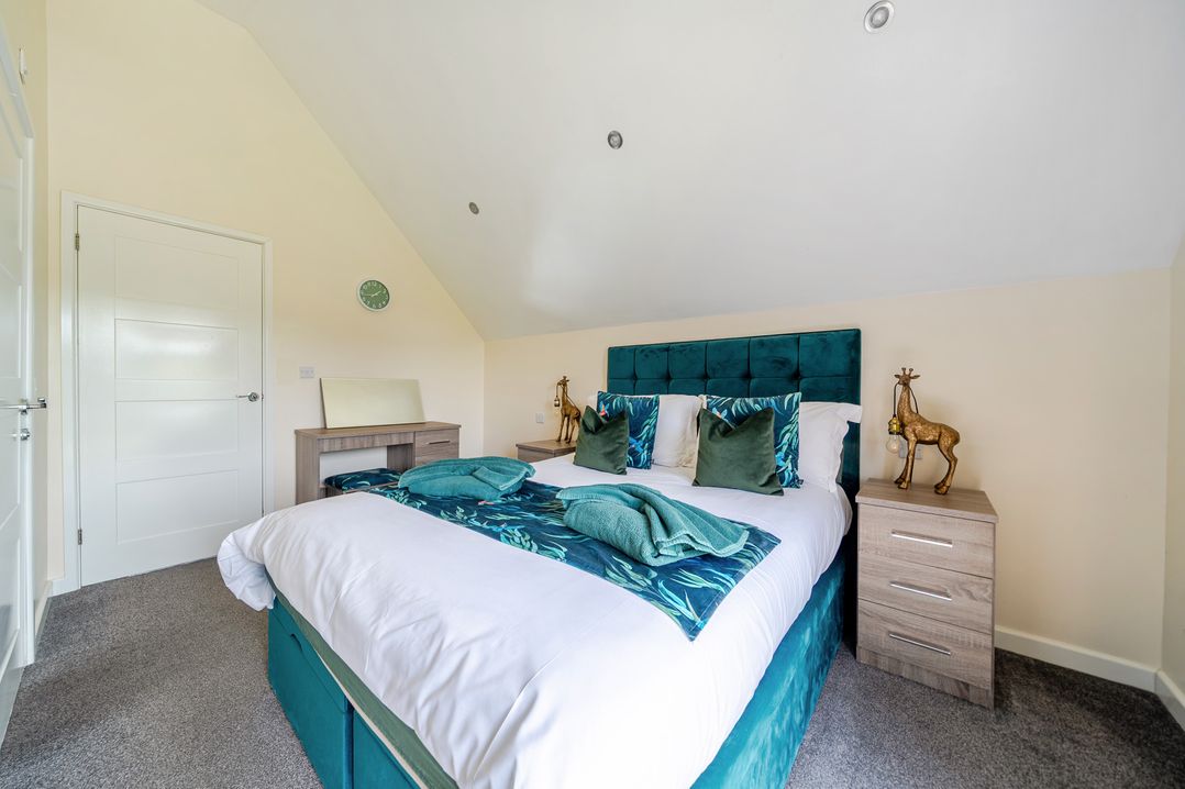 A bedroom with a bed and bedside table at James Ville Marina Lodge 22 in Brigg