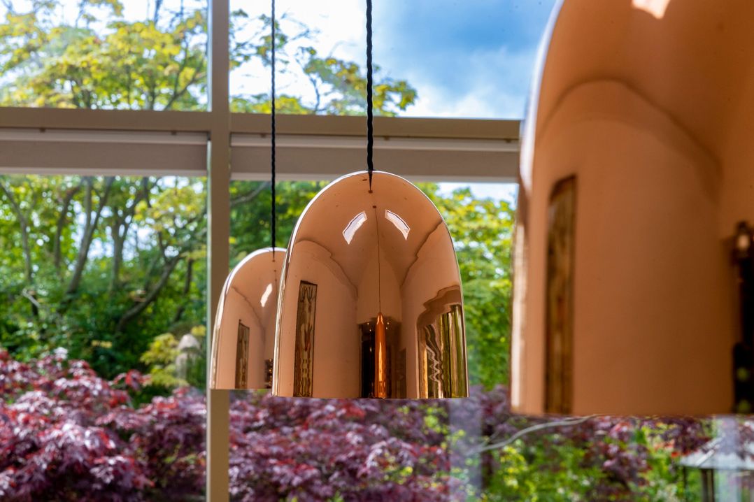 Hanging lamps near a glass window overlooking a garden at 2 The Croft Skipton