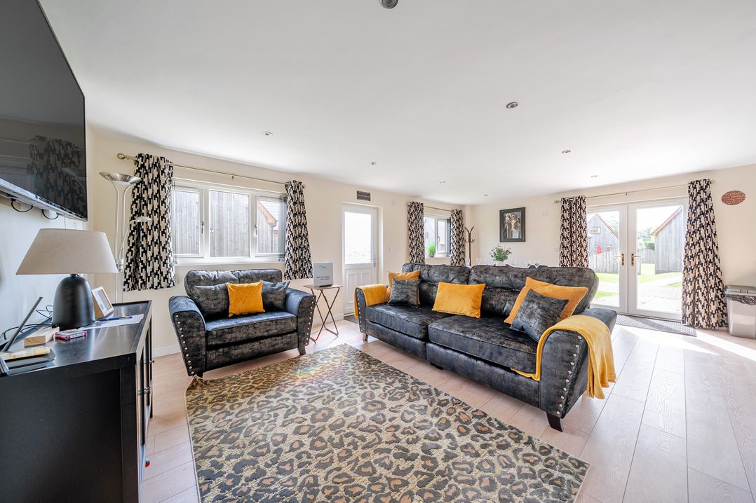 A living room with a sofa and television at Poker Lodge Near Brigg