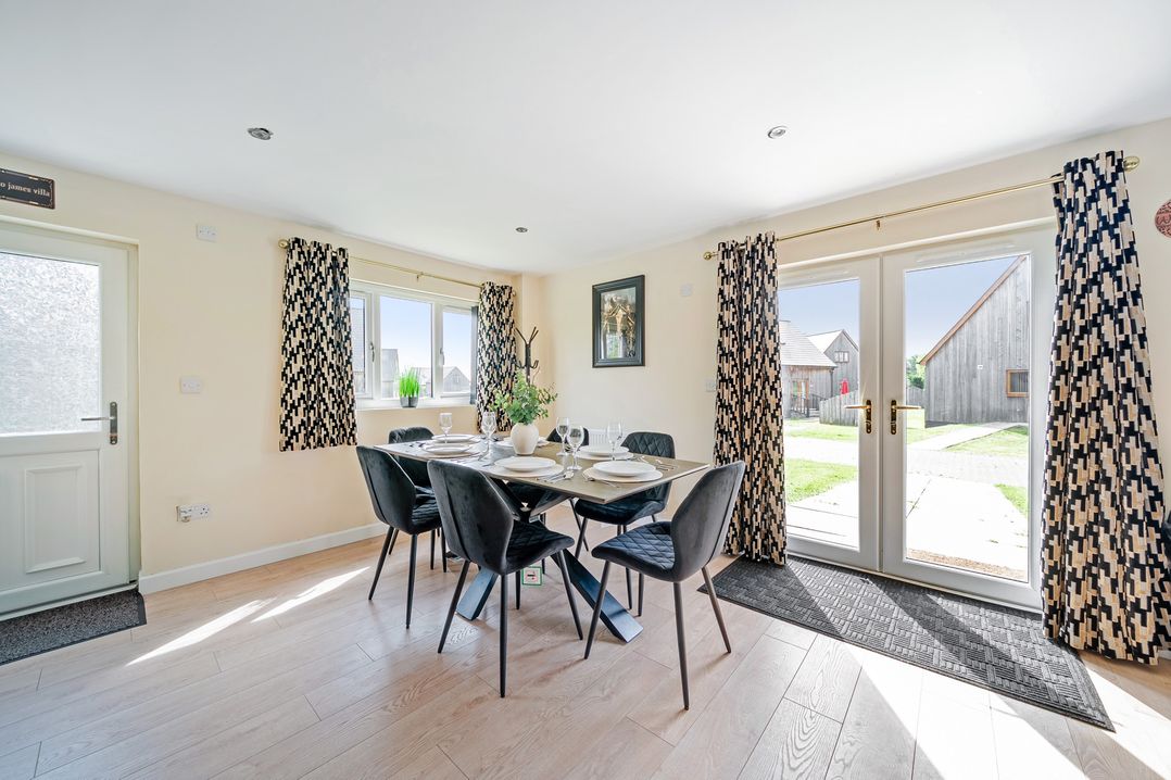 A dining room with a table and chairs at Poker Lodge Near Brigg