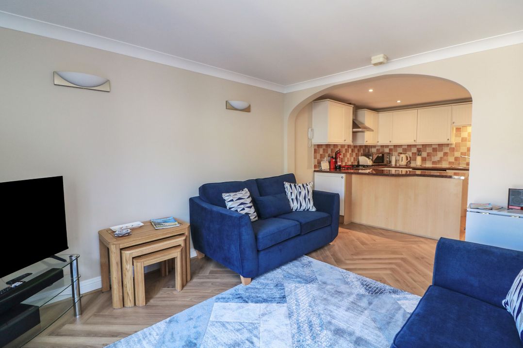 A living room with a sofa and television at 6 Dartmouth House in Dartmouth