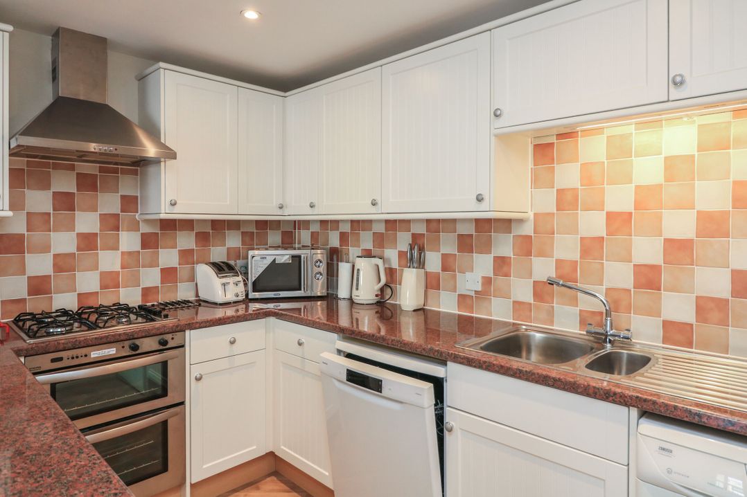 A kitchen with appliances and cabinets at 6 Dartmouth House in Dartmouth