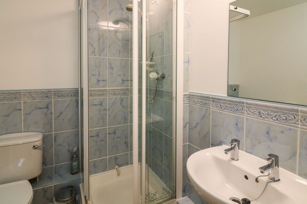 A bathroom with a shower and sink at 6 Dartmouth House in Dartmouth