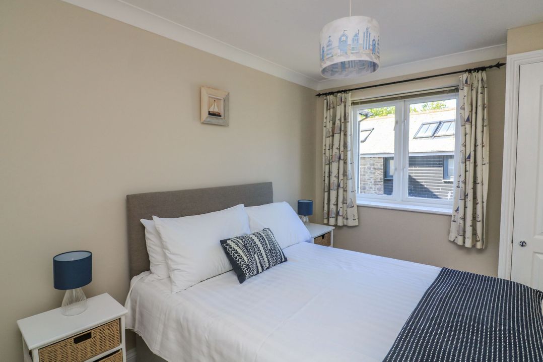 A bedroom with a bed and bedside table at 6 Dartmouth House in Dartmouth
