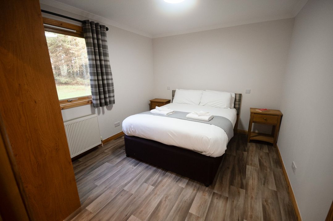 A bedroom with a bed and side tables at Sidlaw Spa in Fowlis near Dundee