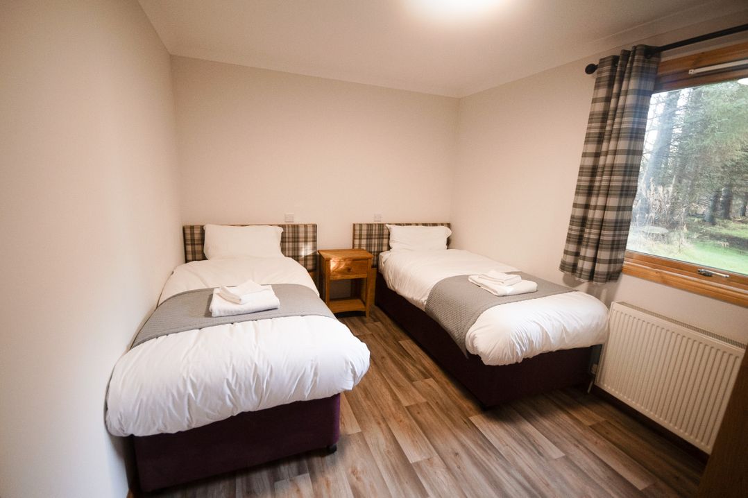 A bedroom with two beds and a window at Sidlaw Spa in Fowlis near Dundee