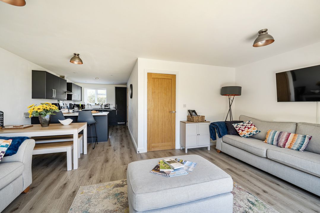 A living room with a sofa and coffee table at Buttercup Cottage St Merryn