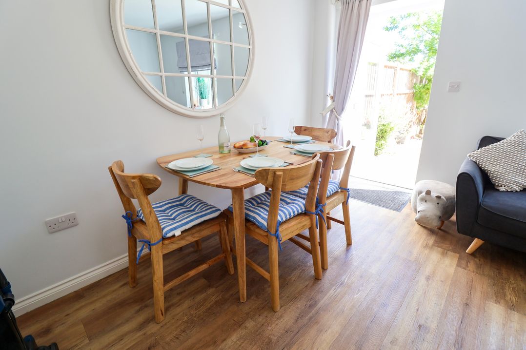 A dining room with a table and chairs at Lapwings, Aldeburgh