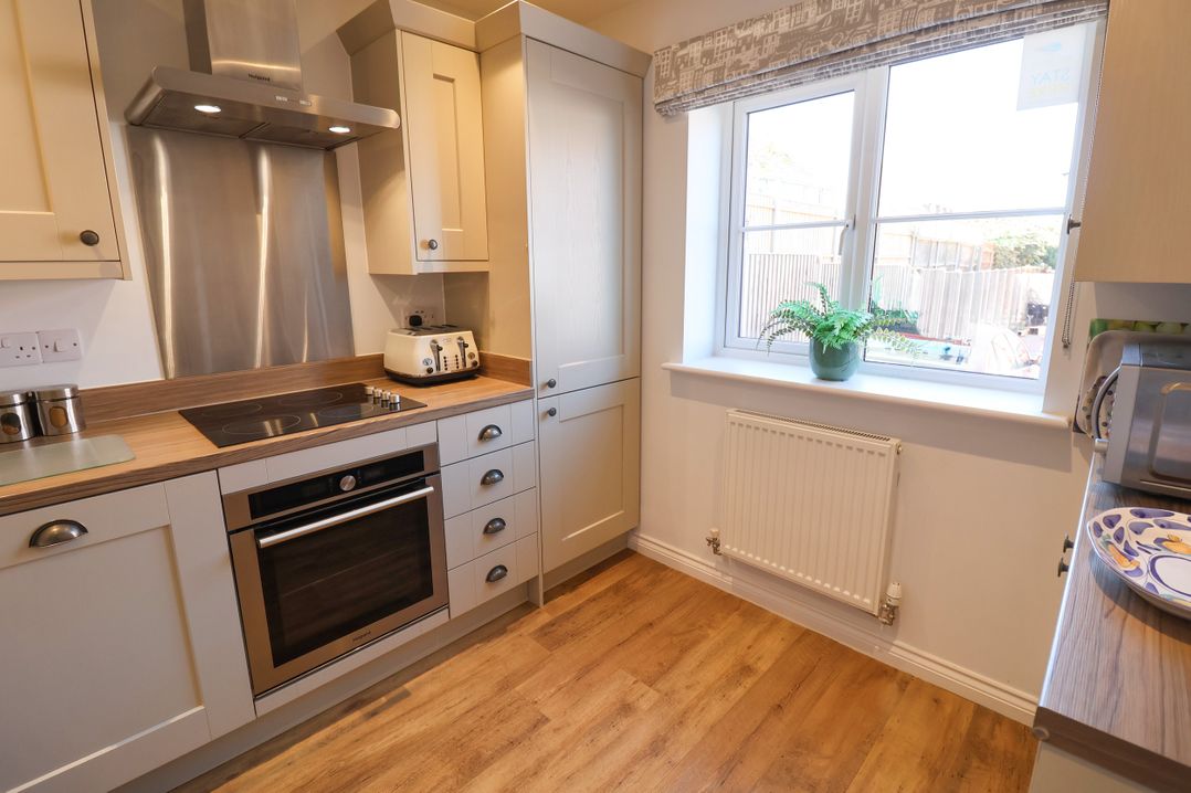 A kitchen with cabinetry and appliances at Lapwings, Aldeburgh