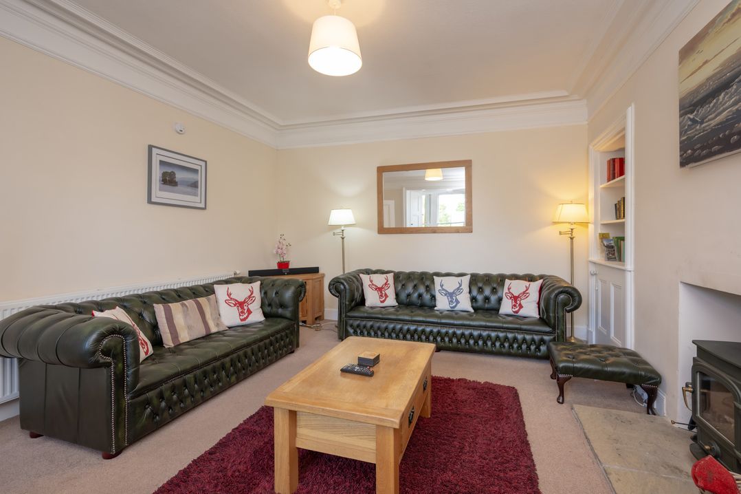 A living room with a sofa and coffee table at Edengrove Aberfeldy