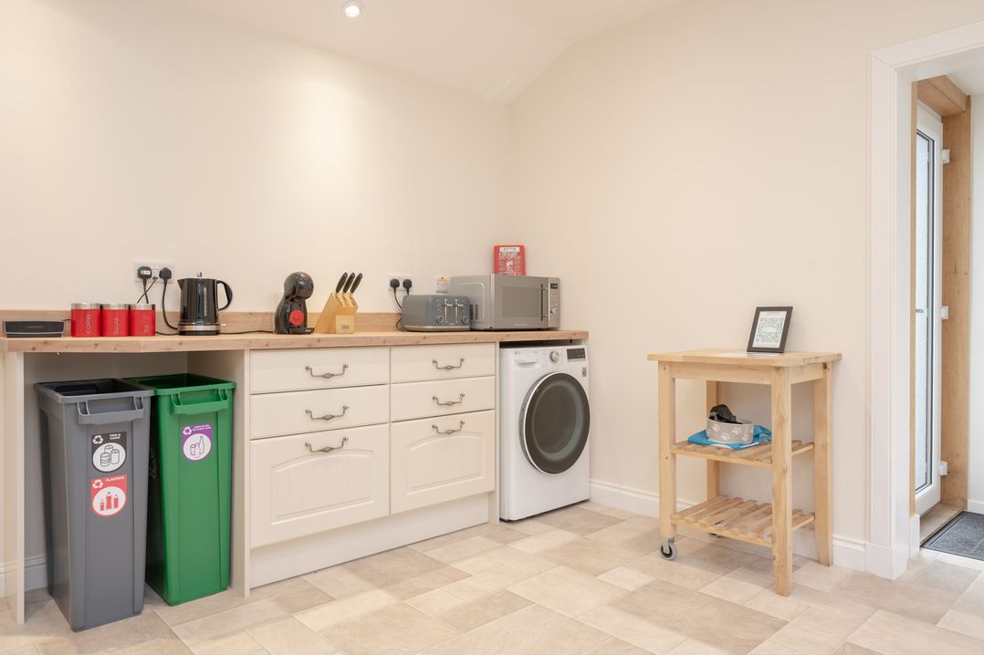 A kitchen with cabinets, appliances and a trolley at Edengrove in Aberfeldy
