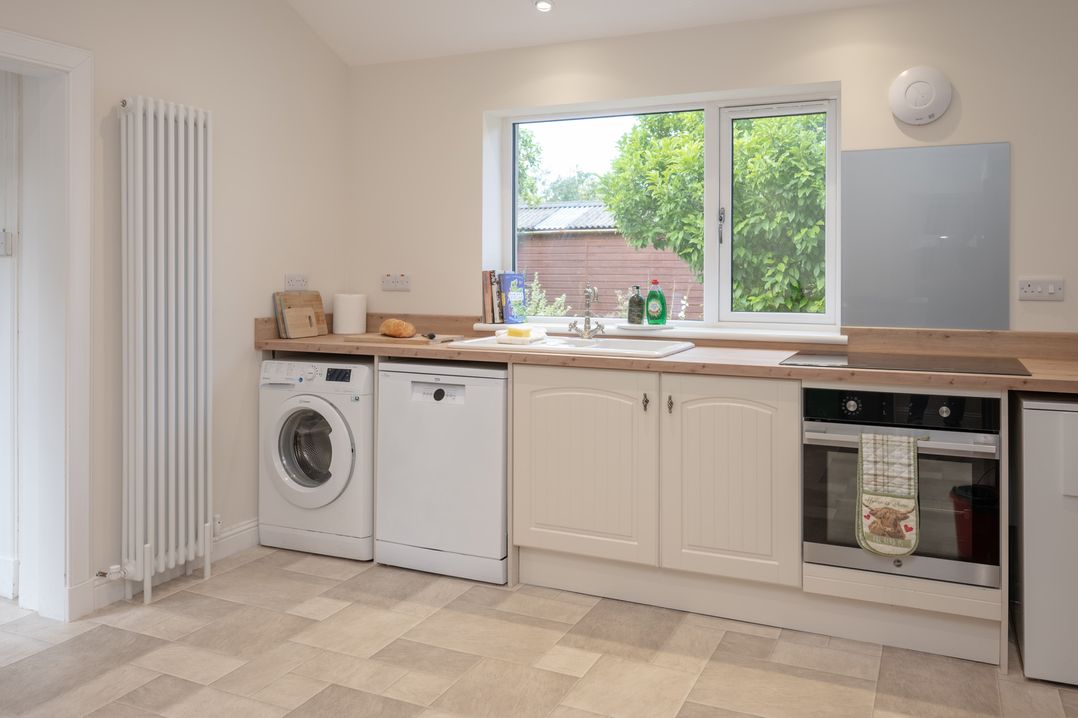 A kitchen with a sink and appliances at Edengrove in Aberfeldy
