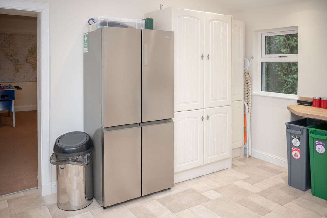 A kitchen with a fridge and cupboard in Edengrove Aberfeldy