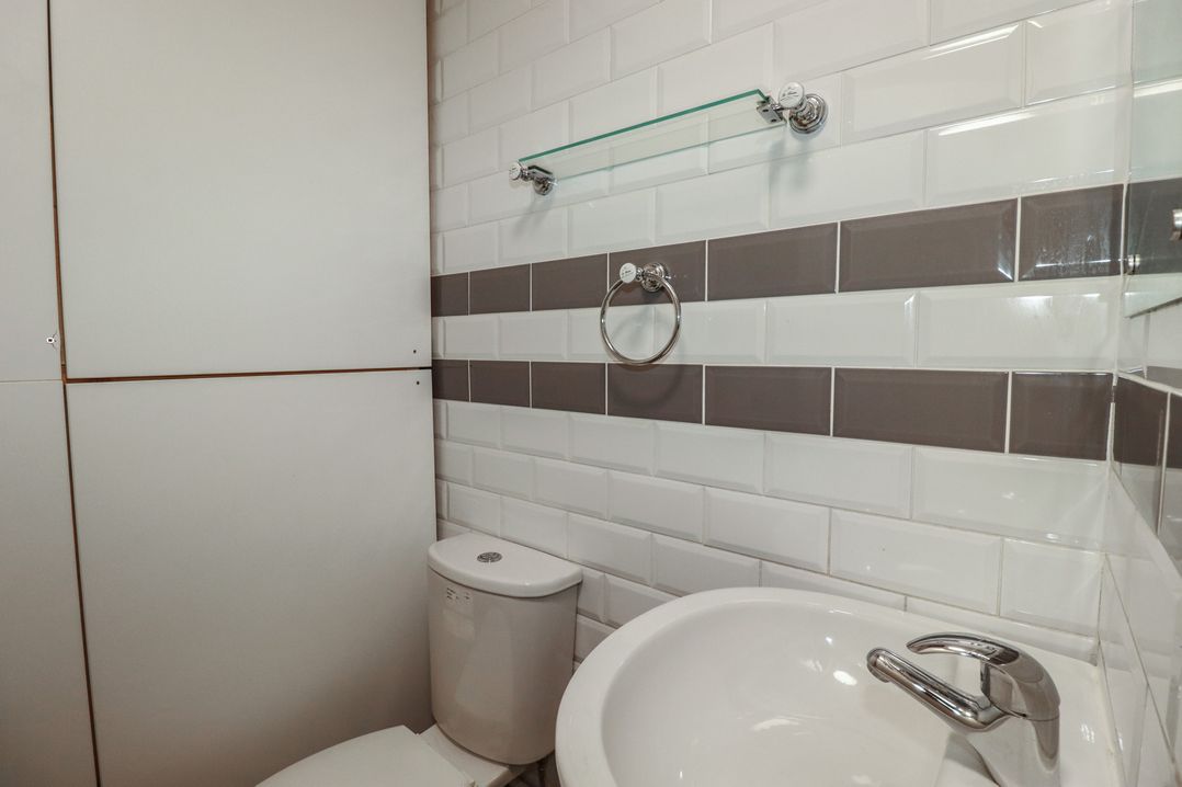 A bathroom with a toilet and sink at Shoreline Apartment No.8 in Newquay