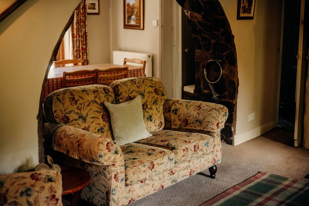 A living room with a sofa and table at The Wilderness in Stiperstones
