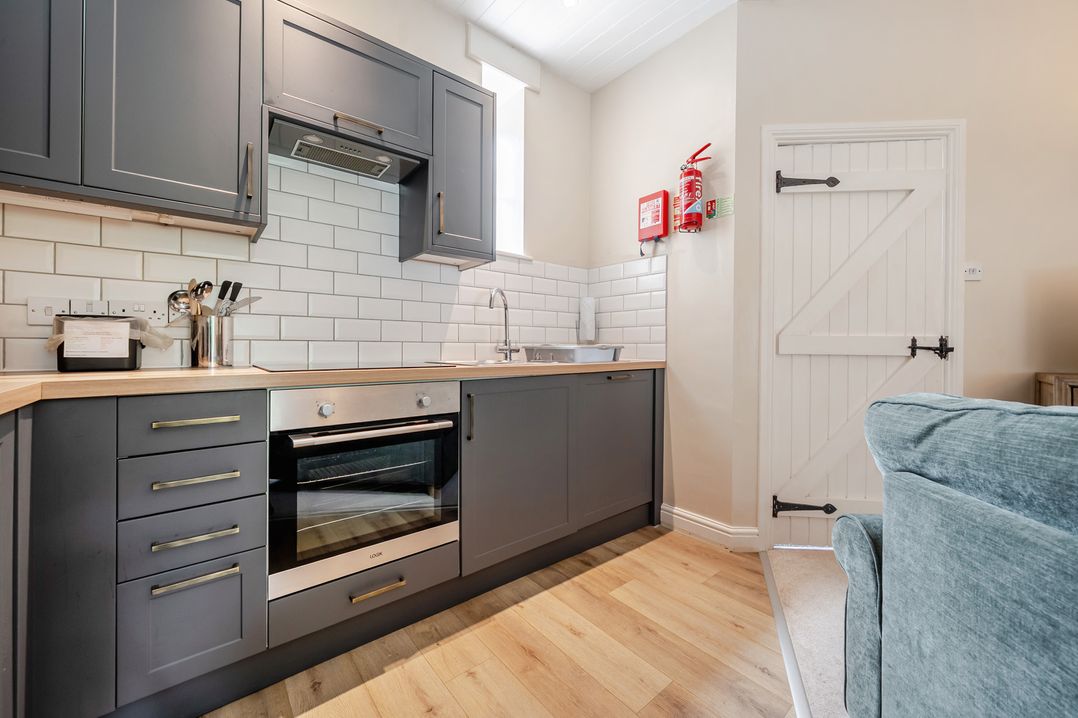 A kitchen with oven and sink at Can Brow at the Graythwaite Estate near Hawkshead