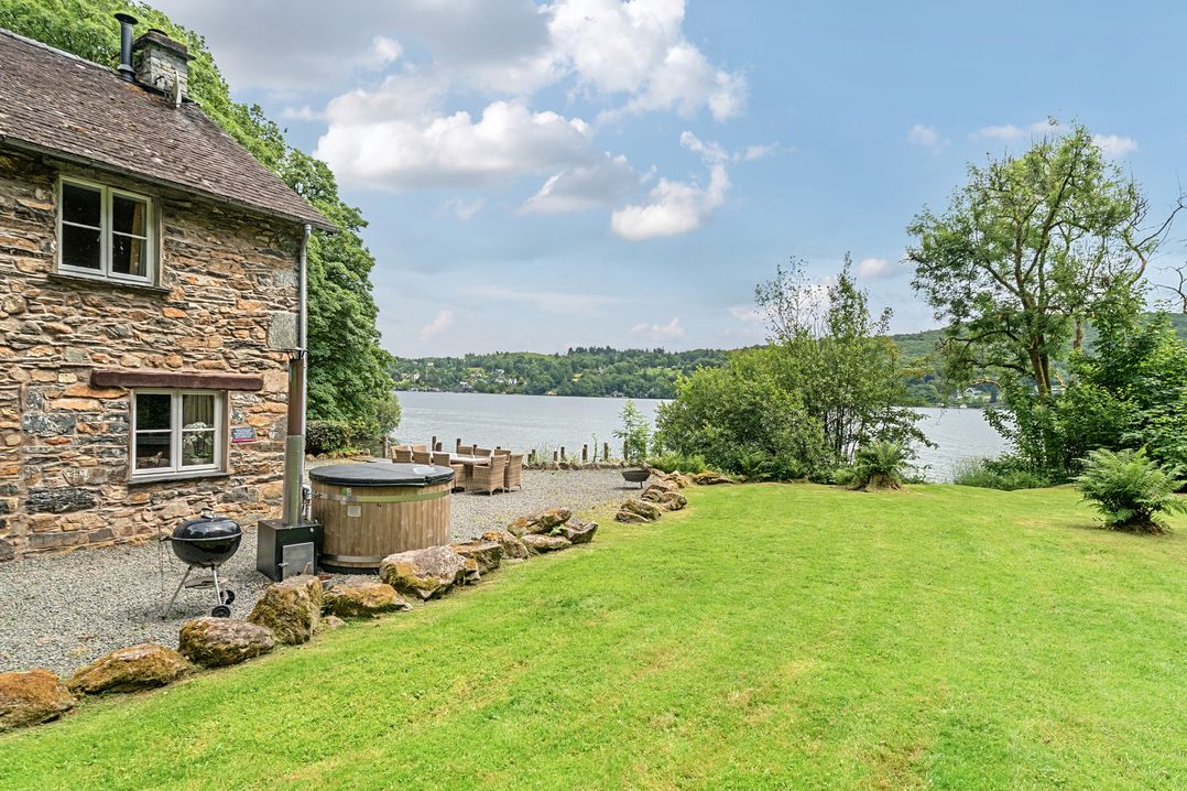 An outdoor space with a house by the lake at Hammerhole at the Graythwaite Estate near Hawkshead