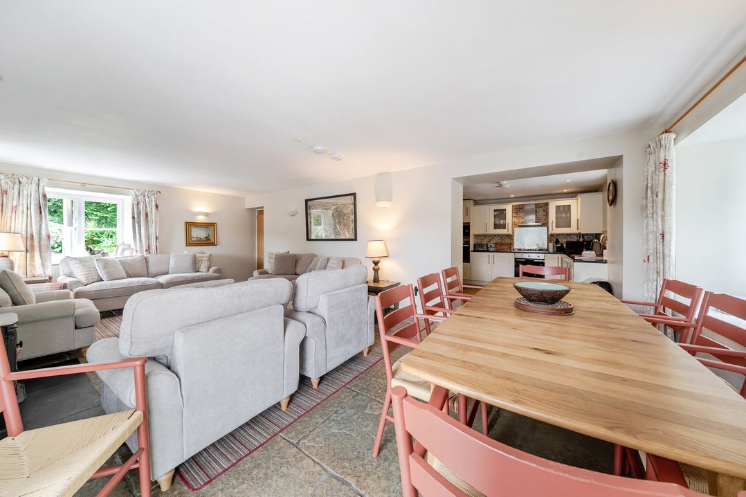 A living room with a sofa and dining table at Hammerhole at the Graythwaite Estate near Hawkshead