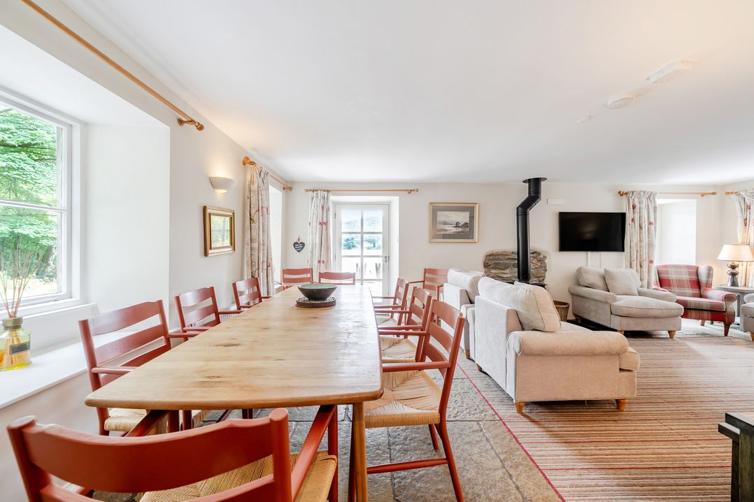 A dining room with a large table and chairs at Hammerhole at the Graythwaite Estate near Hawkshead
