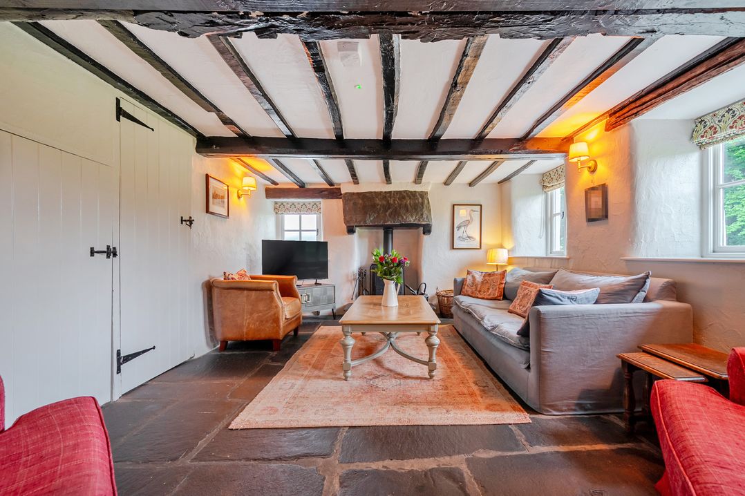 A living room with a sofa and coffee table at Hullet Hall at the Graythwaite Estate near Hawkshead