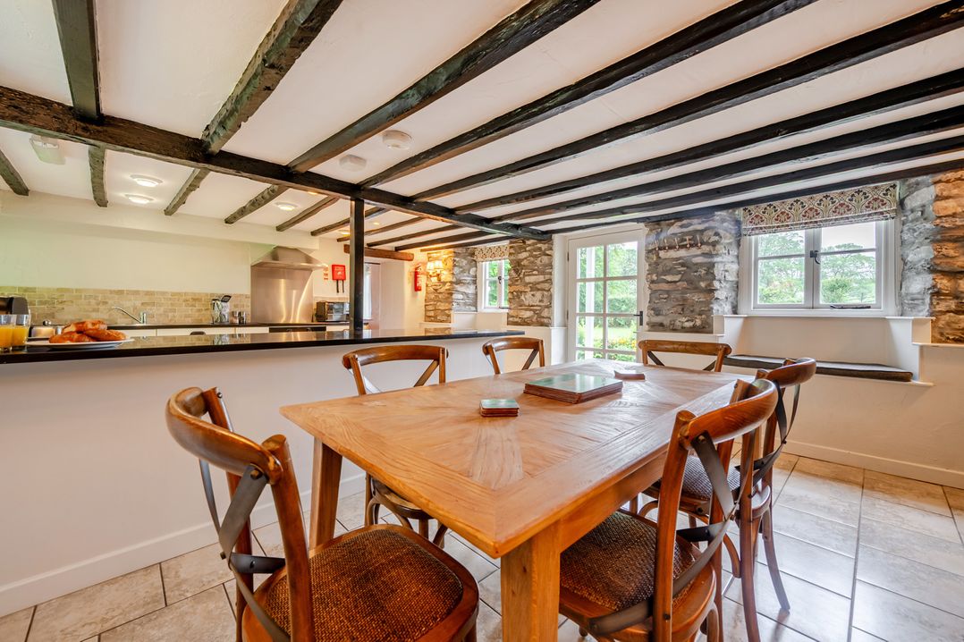 A dining room with a table and chairs at Hullet Hall at the Graythwaite Estate near Hawkshead