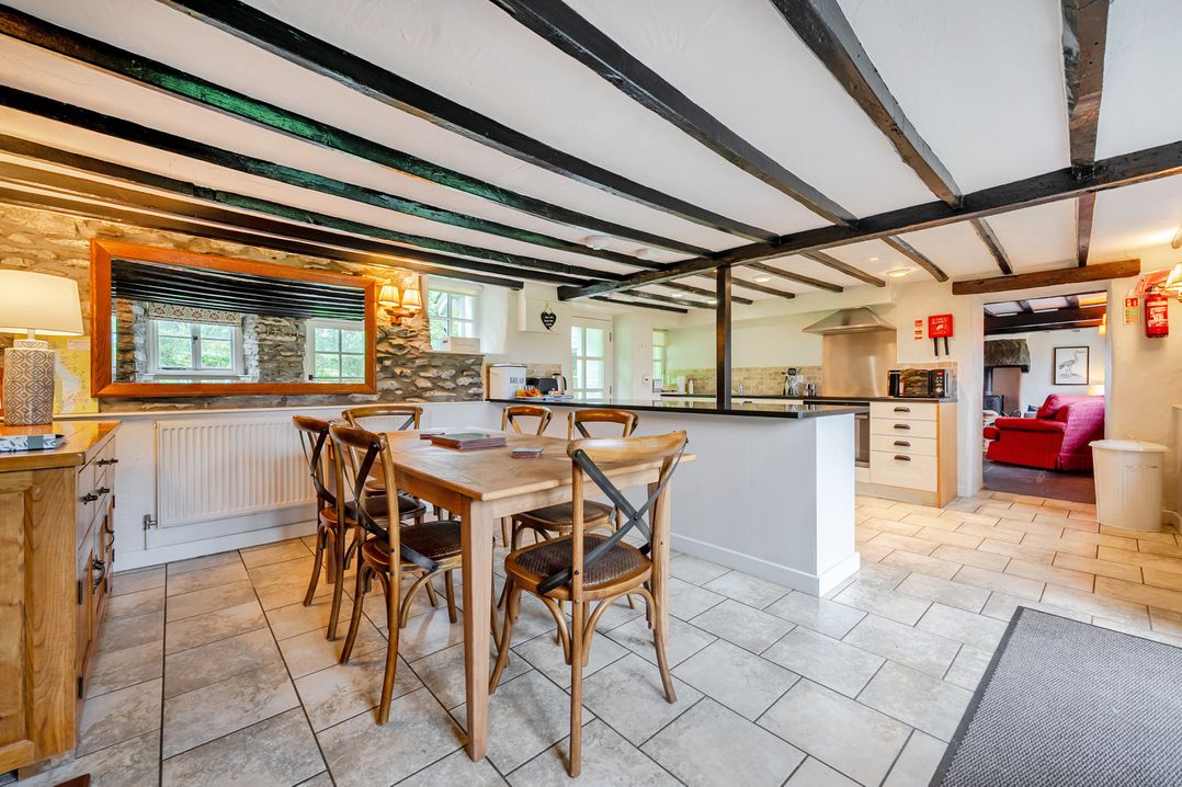 A kitchen with a dining table and chairs at Hullet Hall at the Graythwaite Estate near Hawkshead