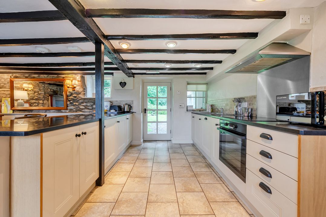 A kitchen with cabinets and appliances at Hullet Hall at the Graythwaite Estate near Hawkshead