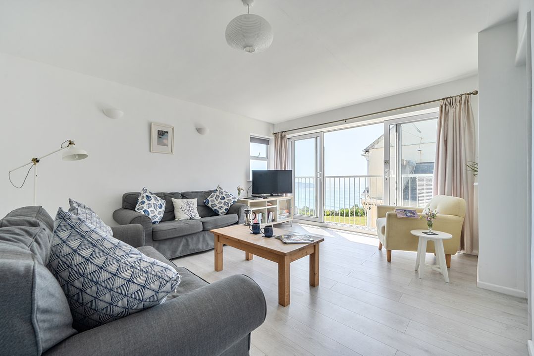 A living room with a sofa and television at Brook House in Sennen Cove near St Just
