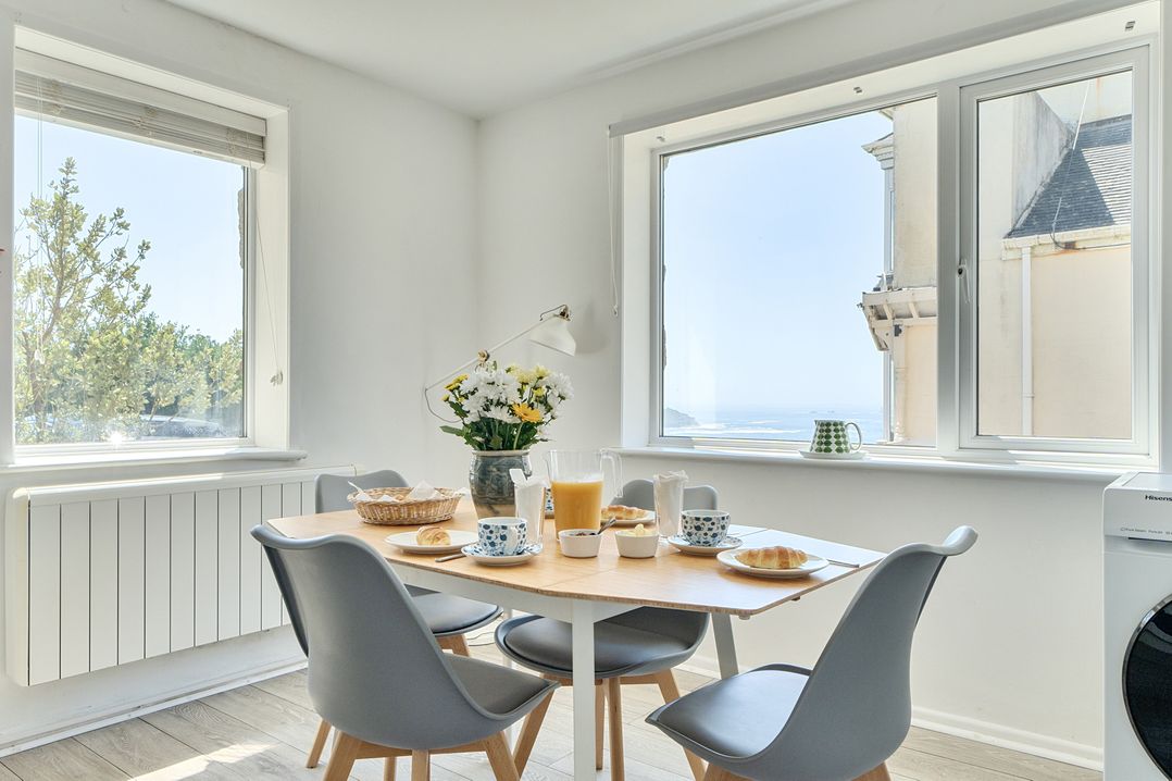 A dining room with a table set for breakfast at Brook House in Sennen Cove near St Just