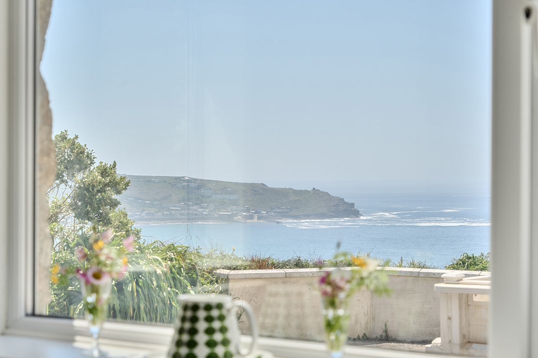 A coastal view from a living room window at Brook House in Sennen Cove near St Just