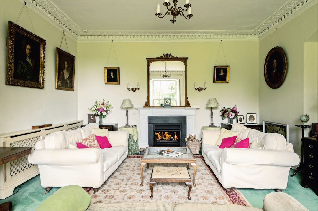 A living room with sofas and a fireplace at Parnacott in Holsworthy