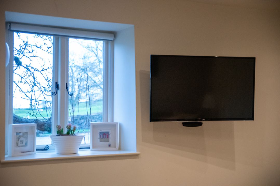 A living room with a window and television at The End Low Ham near Langport