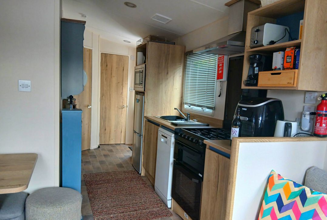 A kitchen with appliances and storage in Porthcurno 5 Perranwell near Goonhavern